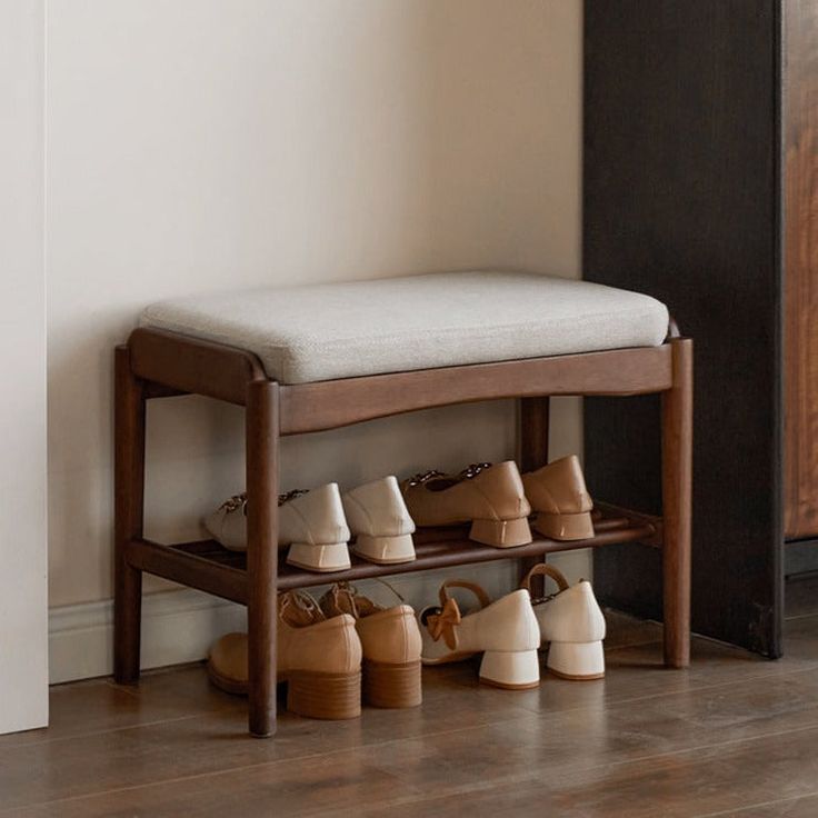 a wooden bench with several pairs of shoes on it