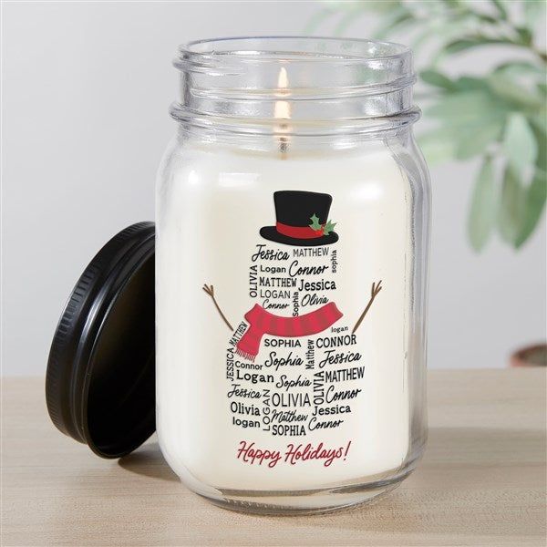 a candle that is sitting on a table with a top hat and ribbon around it