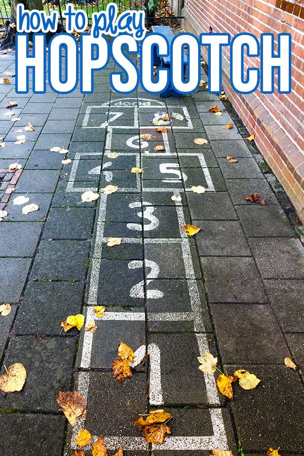 an outdoor hopscotch game with leaves on the ground