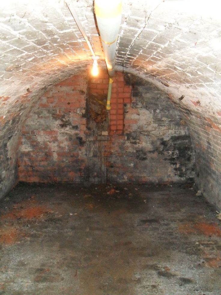 the light is shining in an old brick tunnel