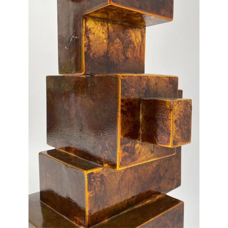 a sculpture made out of brown blocks on top of each other