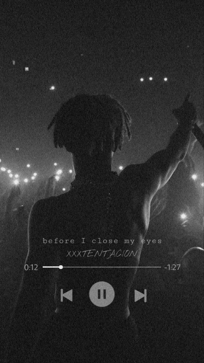 a black and white photo of a person with dreadlocks on his head in the dark