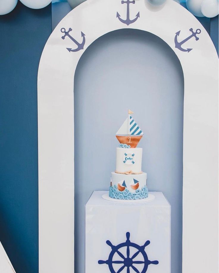 a blue and white cake with an anchor on top