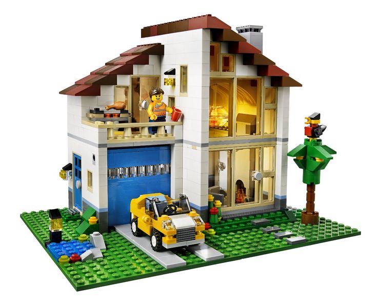 a lego house with cars parked in front of it