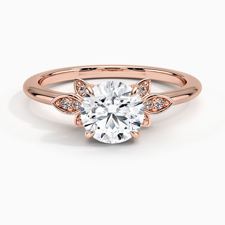 a rose gold engagement ring with three stones