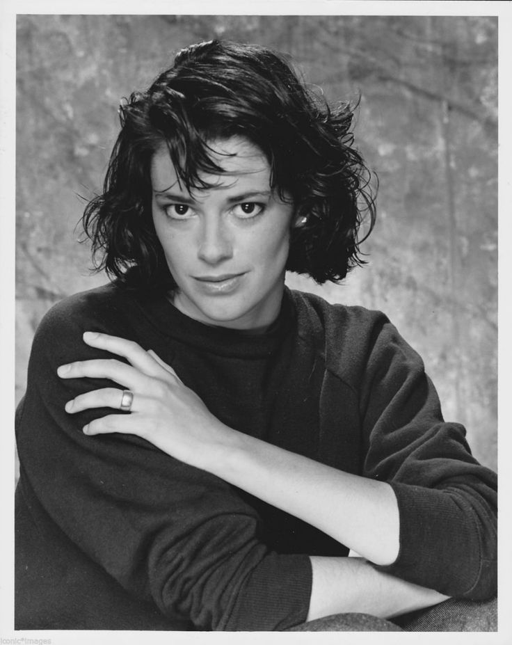 a black and white photo of a woman with her arms crossed