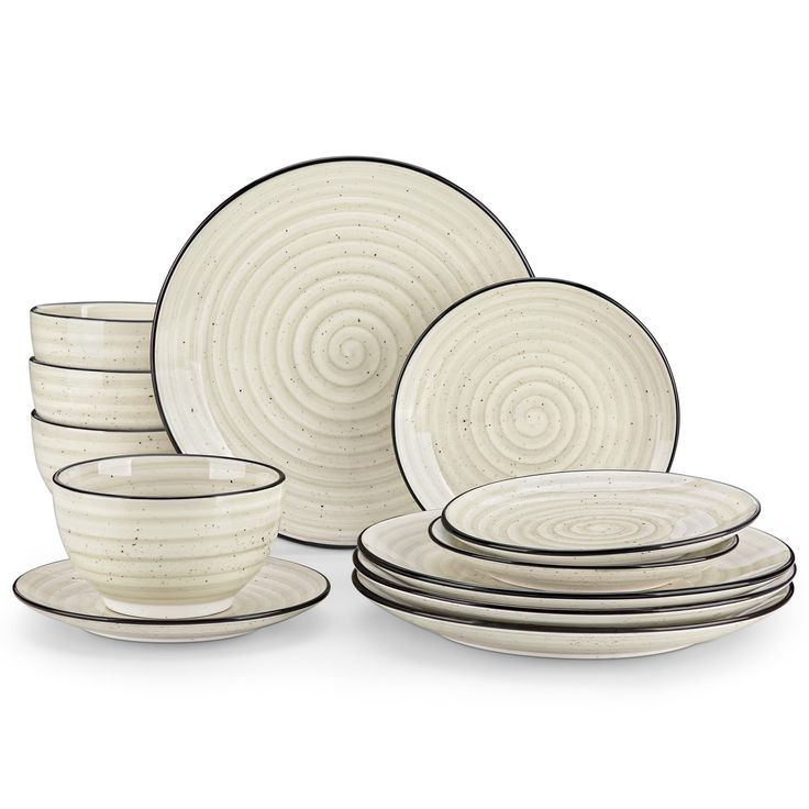 a set of white dishes with black rims