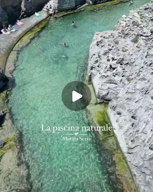 people are swimming in the water near some rocks and sand, with text that reads la piscina naturale marina serra