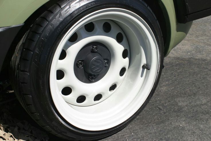 the wheel of a green car with white spokes