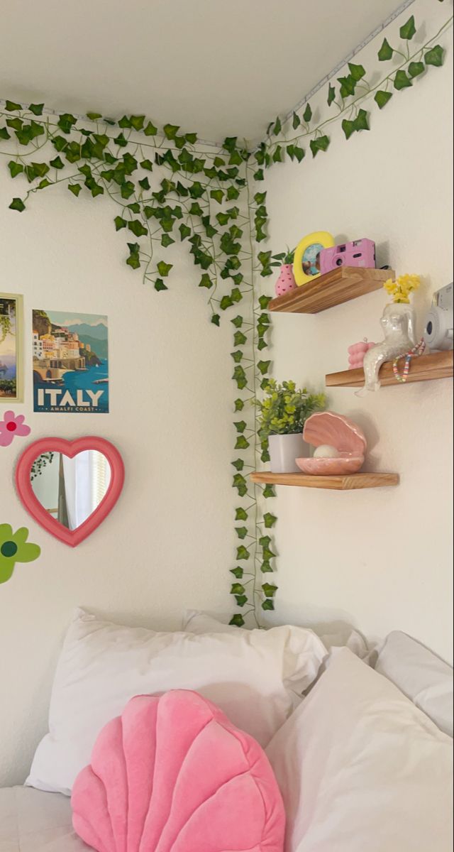 a bedroom with white walls and ivy growing up the side of the wall above the bed