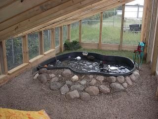 an outdoor hot tub in the middle of a room with rocks and gravel around it