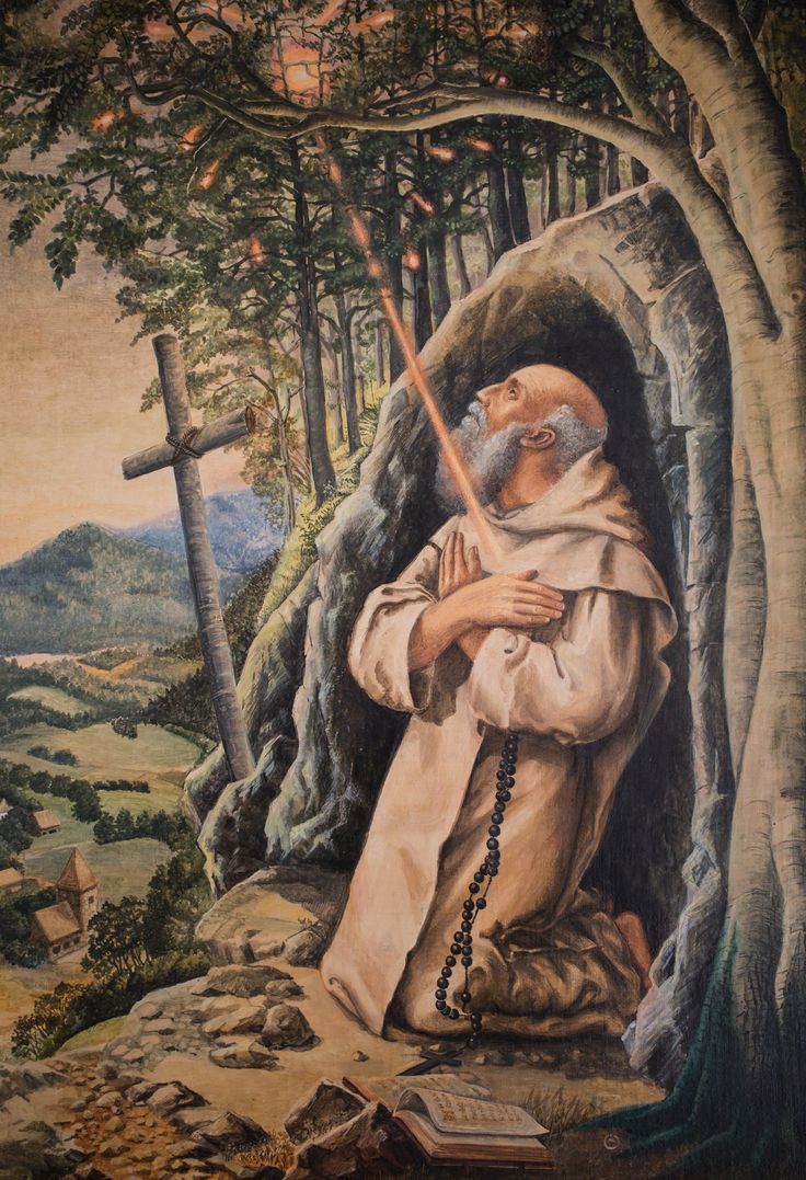 an old man holding a cross in his hand