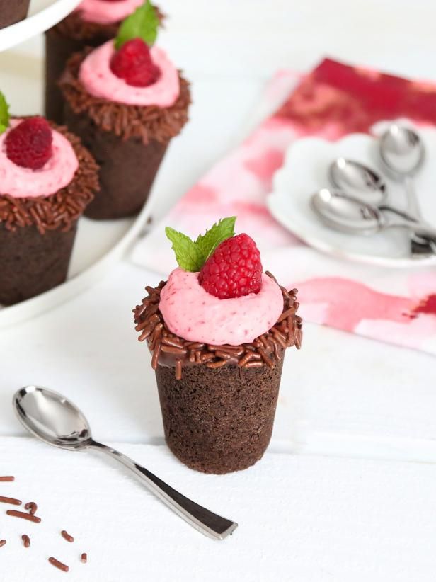 chocolate cupcakes with raspberry frosting and sprinkles on top