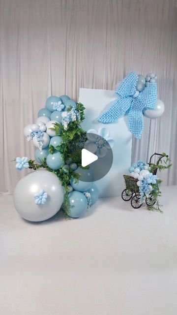 blue and white balloons are on display in front of a backdrop with the words baby's breath