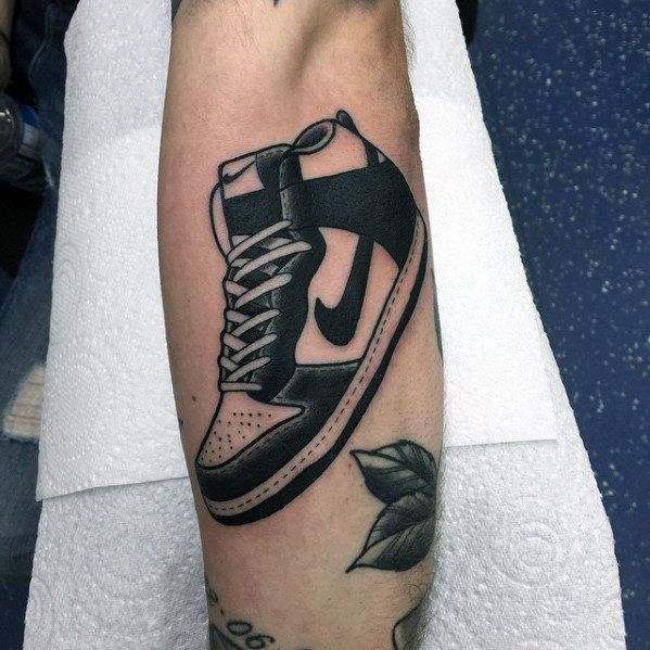 a black and white tattoo of a shoe