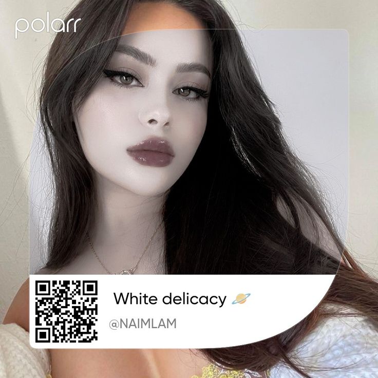 a woman with long dark hair is wearing a white dress and has a qr code on her chest