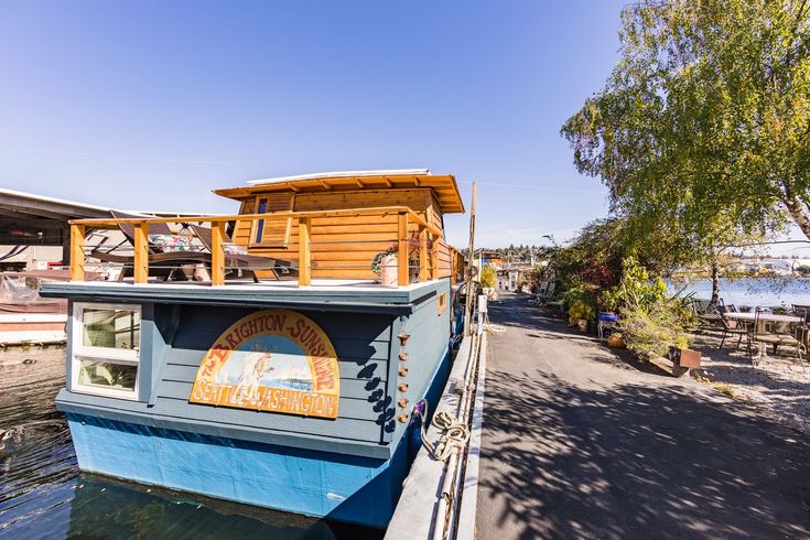 a blue boat is docked on the water