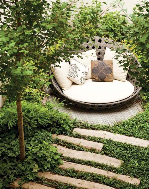 an outdoor seating area surrounded by greenery