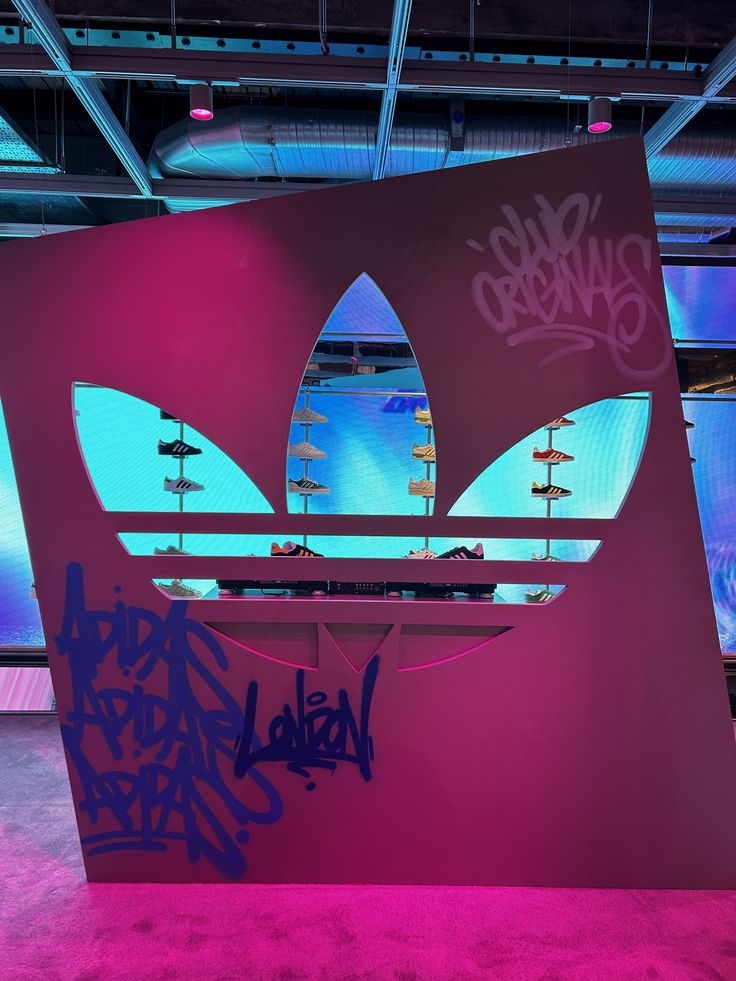 the adidas sign has been spray painted purple and blue