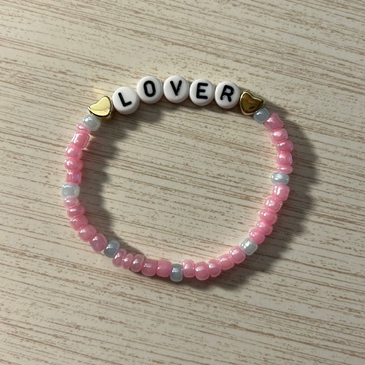 Lover Beaded Taylor Swift Friendship Bracelet Perfect For Trading At The Eras Tour, Or For A Swiftie! Please Bundle And I Can Offer You A Discount I Can Ship Day Off Or Next Day! (Beaded Concert Bracelets) Pink Casual Beaded Bracelets For Valentine's Day, Pink Beaded Bracelets With Letter Beads For Valentine's Day, Pink Beaded Bracelet With Letter Beads For Valentine's Day, Pink Heart-shaped Friendship Bracelets With Letter Beads, Pink Heart Friendship Bracelet With Letter Beads, Pink Heart-shaped Beaded Bracelets With Letter Beads, Lover Bracelets Taylor Swift, Lover Friendship Bracelet, Freindship Bracelets