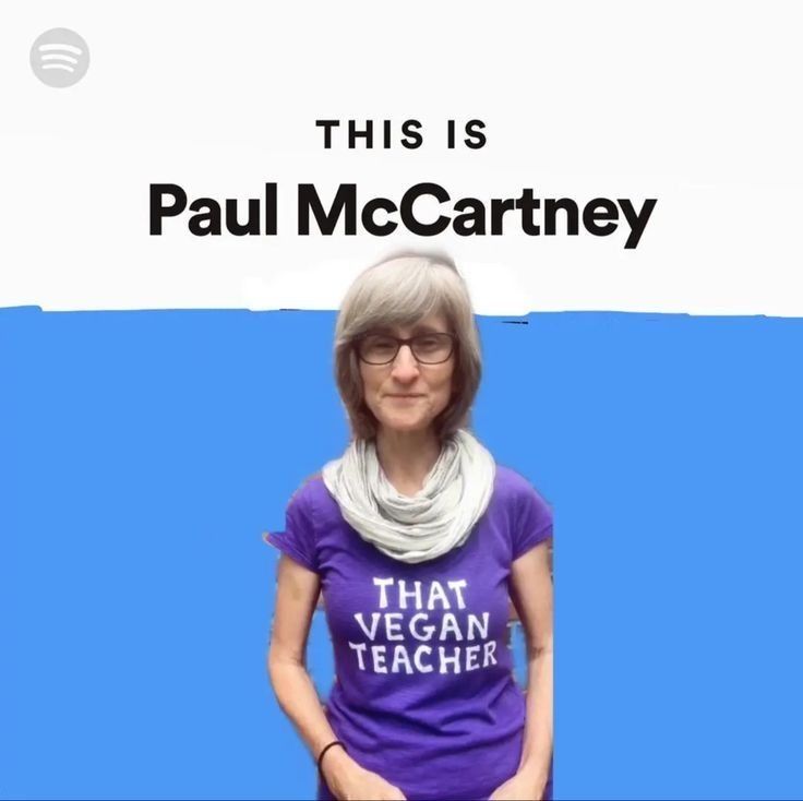 an older woman wearing a purple shirt with the words, this is paul mccartney