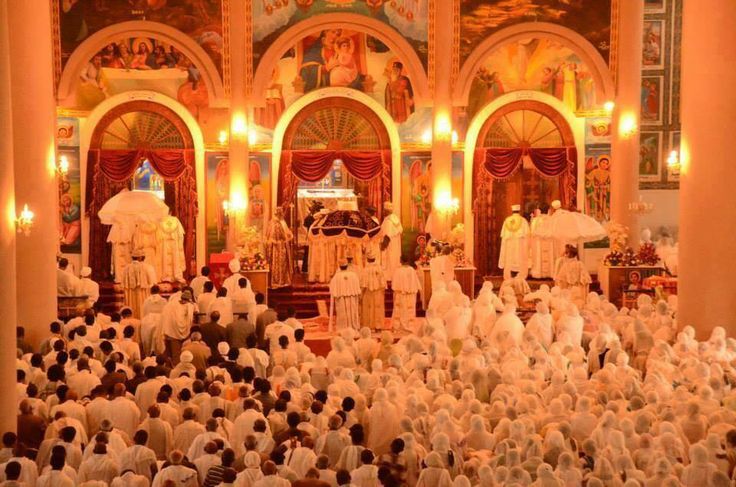 a large group of people standing in front of a church with an altar and alter