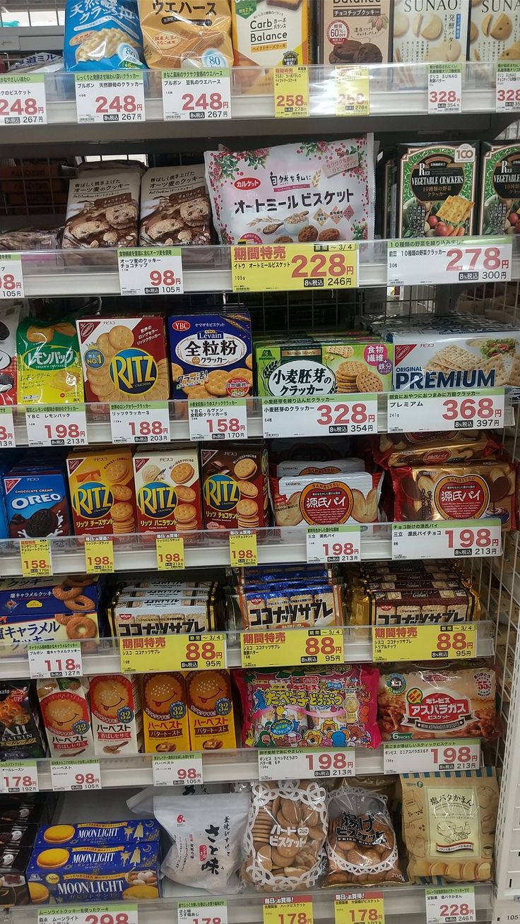 the shelves are filled with different kinds of snacks and desserts for sale in a grocery store