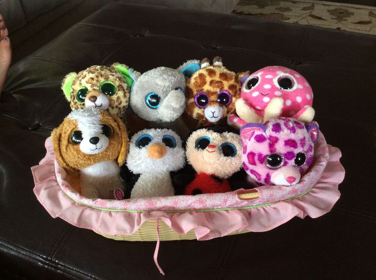 a group of stuffed animals sitting in a basket