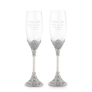 two champagne glasses with silver glitter on the rims