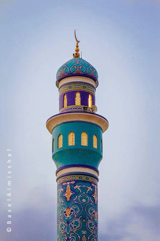 a tall blue and white tower with a clock on it's side