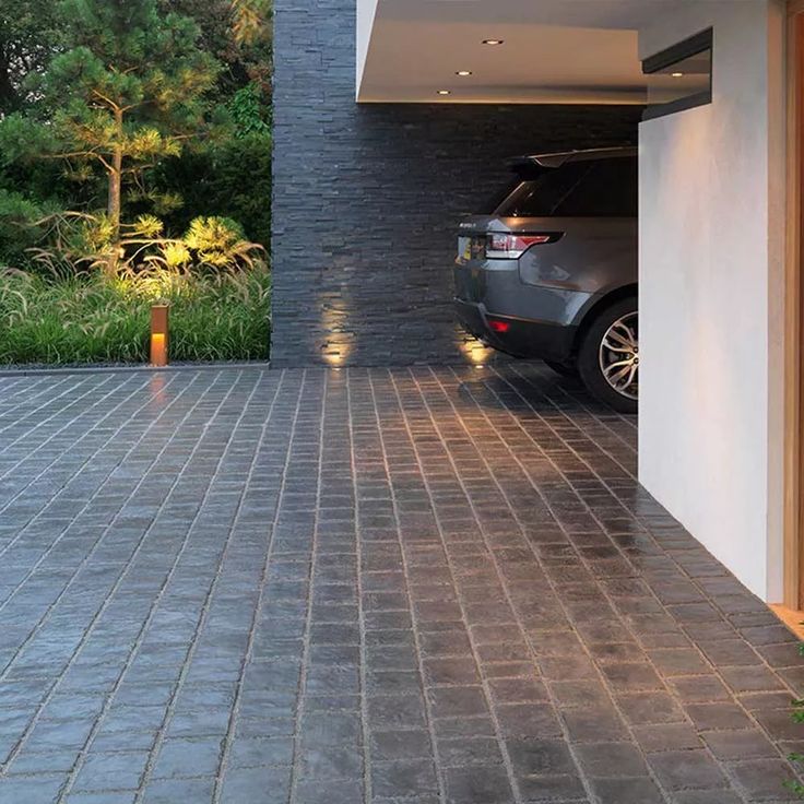 a car is parked in the garage with its door open