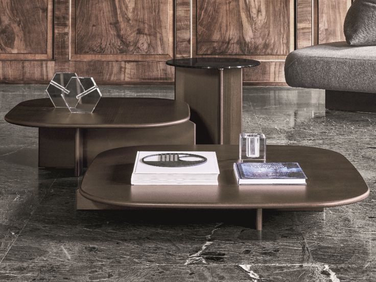 a coffee table sitting on top of a marble floor next to a couch and chair