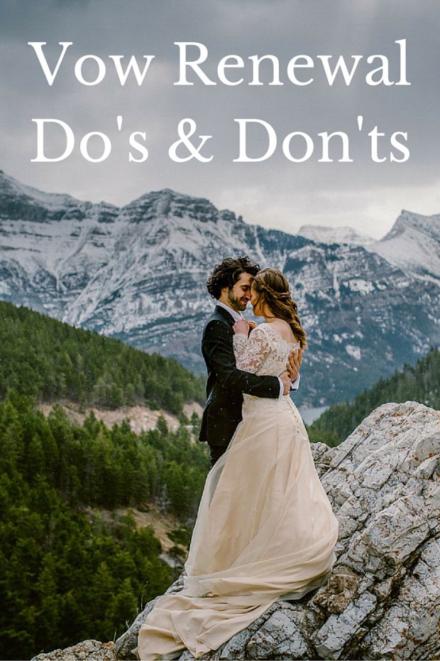 a man and woman standing on top of a mountain