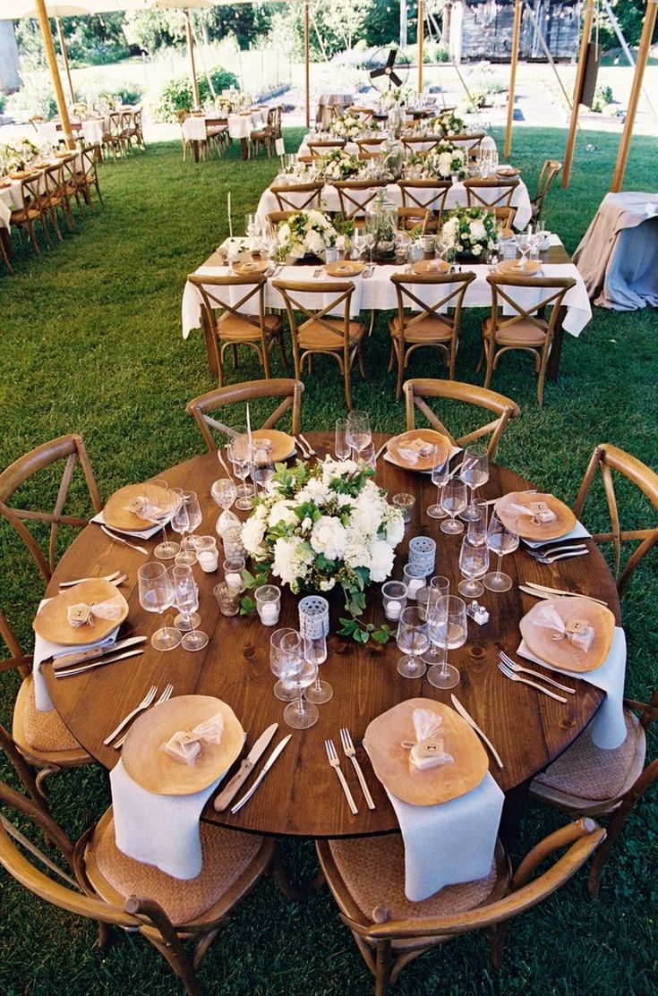 a table set up for an outdoor wedding reception