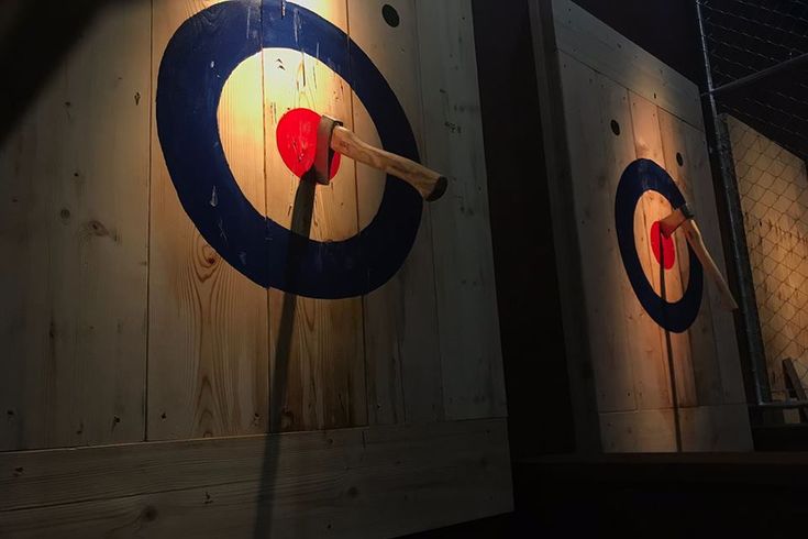 three wooden target boards with arrows on them