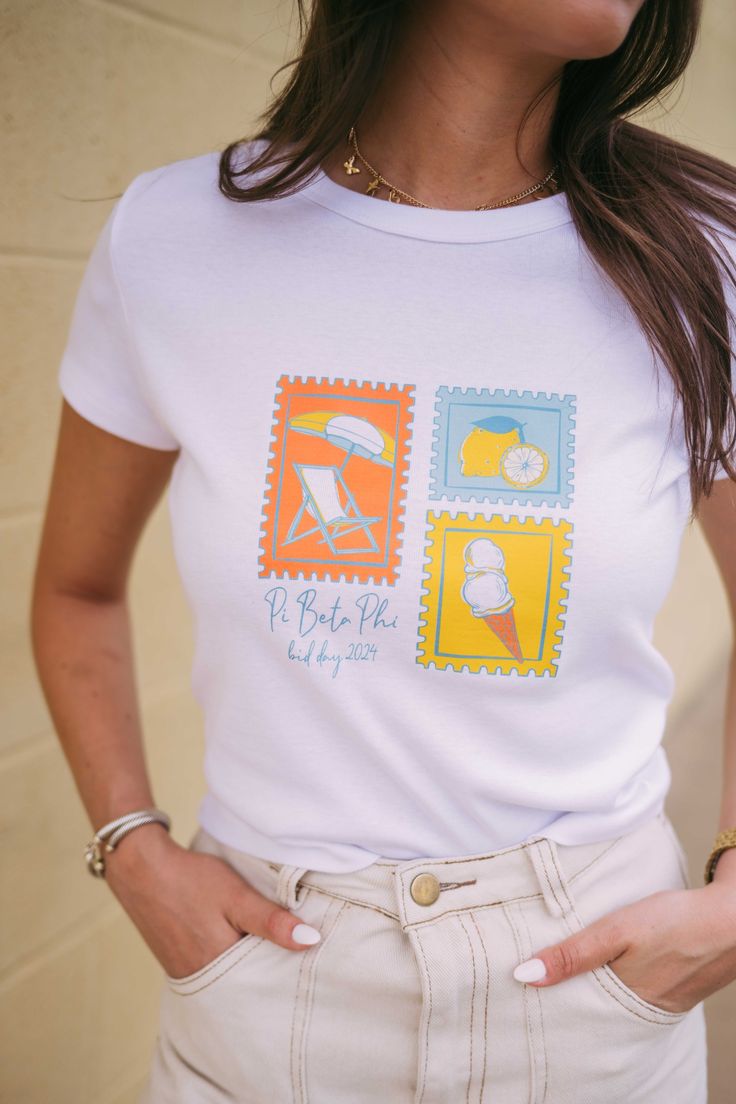 a woman wearing a white t - shirt with stamps on it