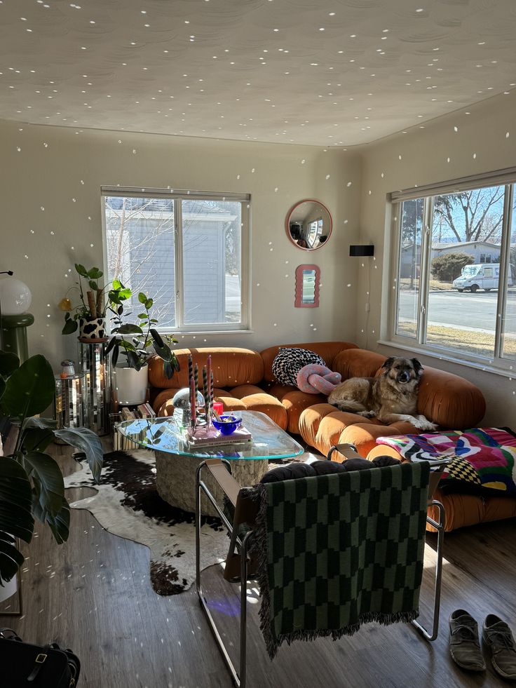 a living room filled with furniture and lots of windows