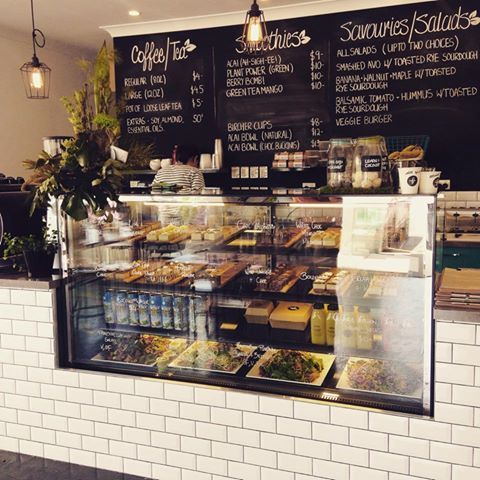 the inside of a deli with lots of food