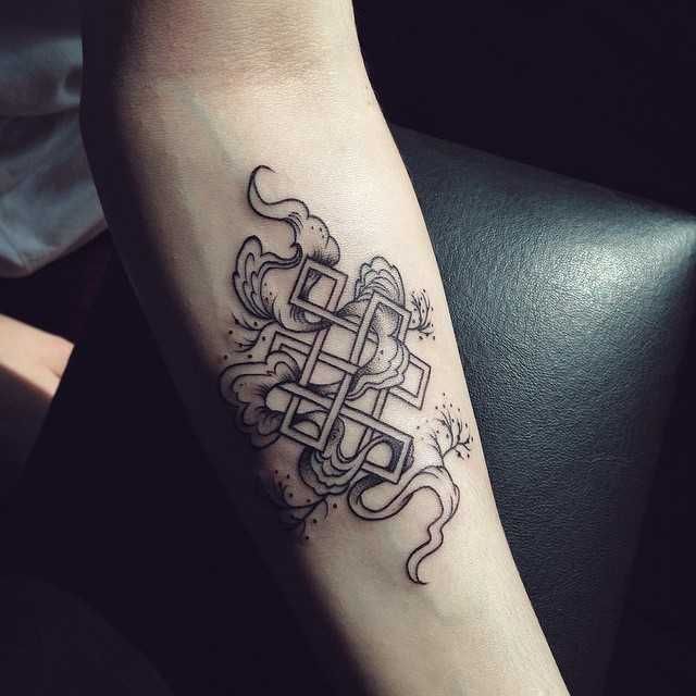 a black and white tattoo design on the arm