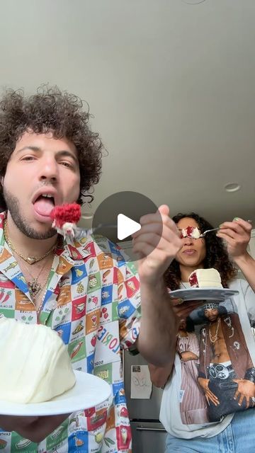 two people are eating cake and one is holding a plate with the other hand on it