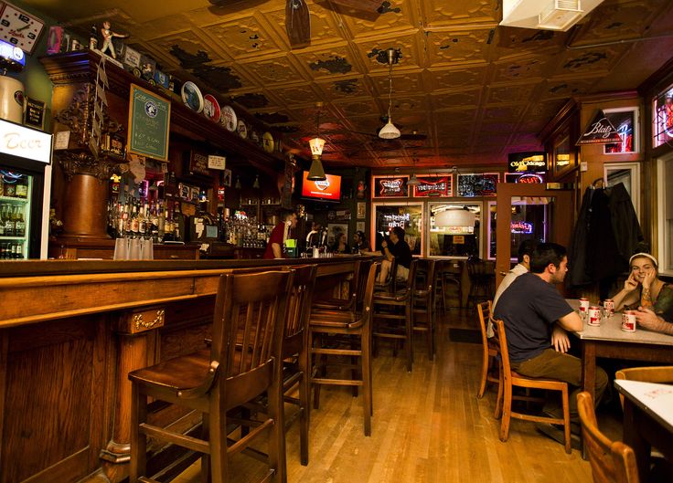 people sitting at tables in a bar area