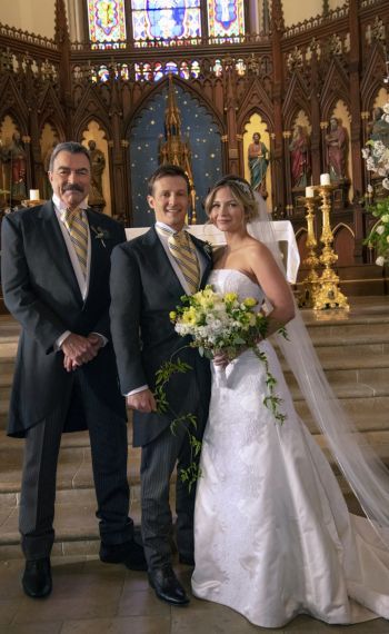 a bride and groom posing for a photo in front of the alter at their wedding