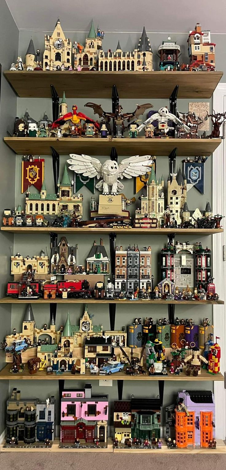 a shelf filled with lots of different types of toy cars and trucks on top of wooden shelves