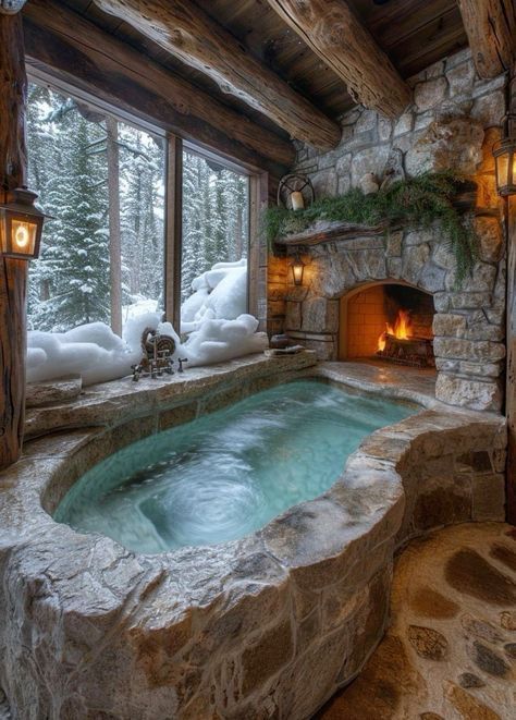 an indoor hot tub in the middle of a room with stone walls and fireplaces