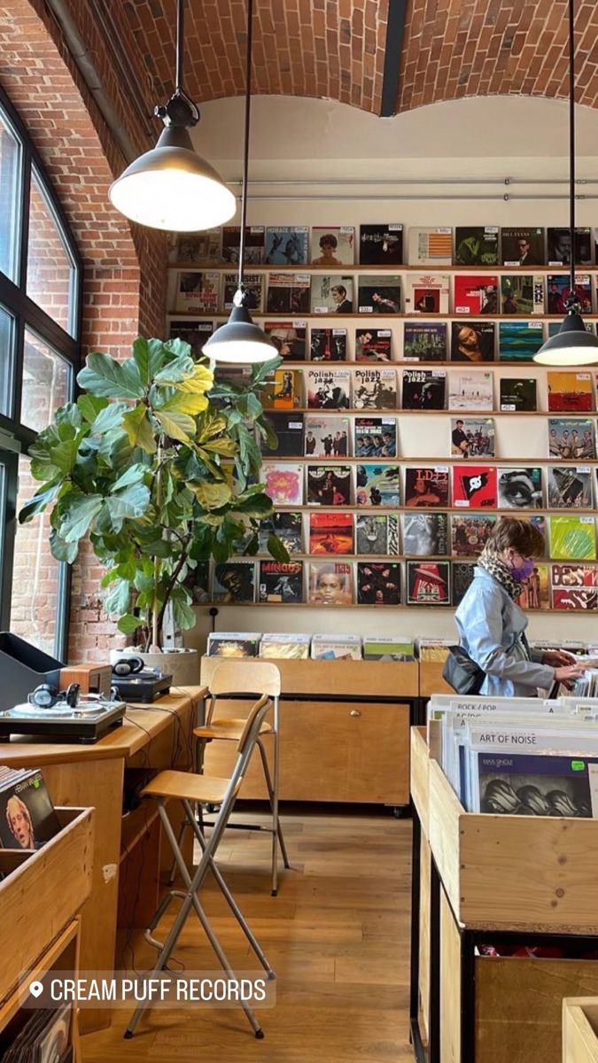 a room filled with lots of books and desks