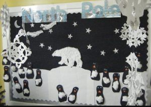 a bulletin board with penguins and polar bears on it, surrounded by snowflakes