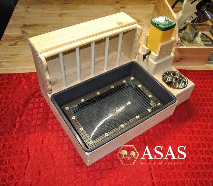 a wooden box with an open lid on a red table cloth next to other items