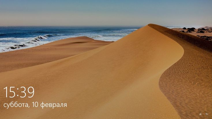 an image of the ocean and sand dunes