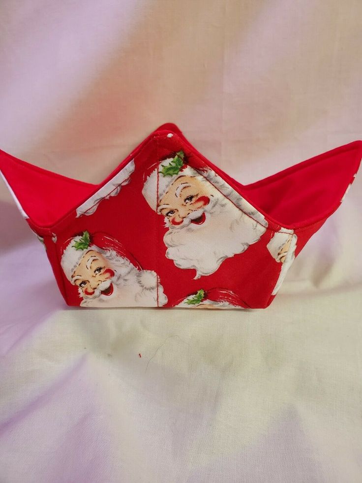 a red santa claus paper boat on a white sheet