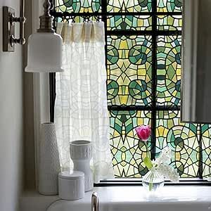 a bathroom with a stained glass window and sink